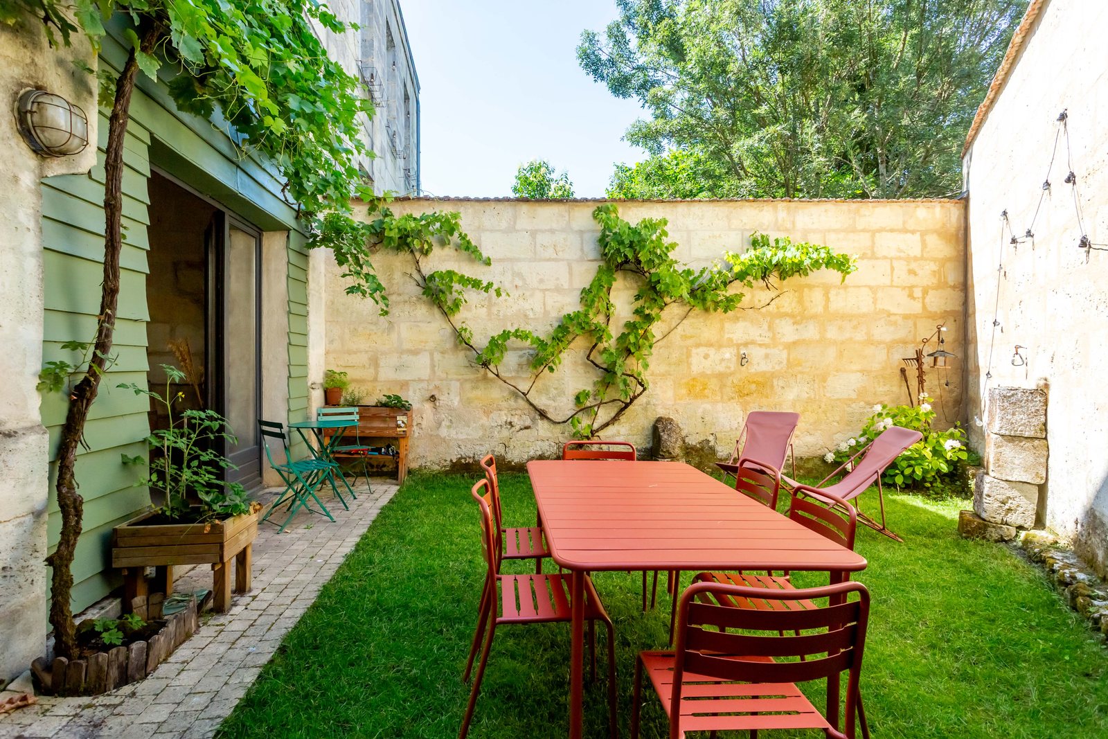 Jardin clos avec vigne et table